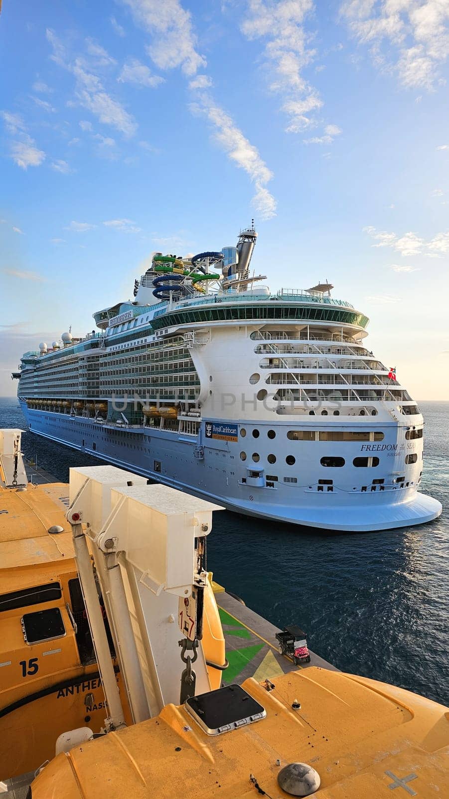 Cape Canaveral, FL USA - 02.12.2024: Giant Cruise Ship Sailing on the Ocean with Clear Blue Skies and Cloudy Weather, Sunny Day.