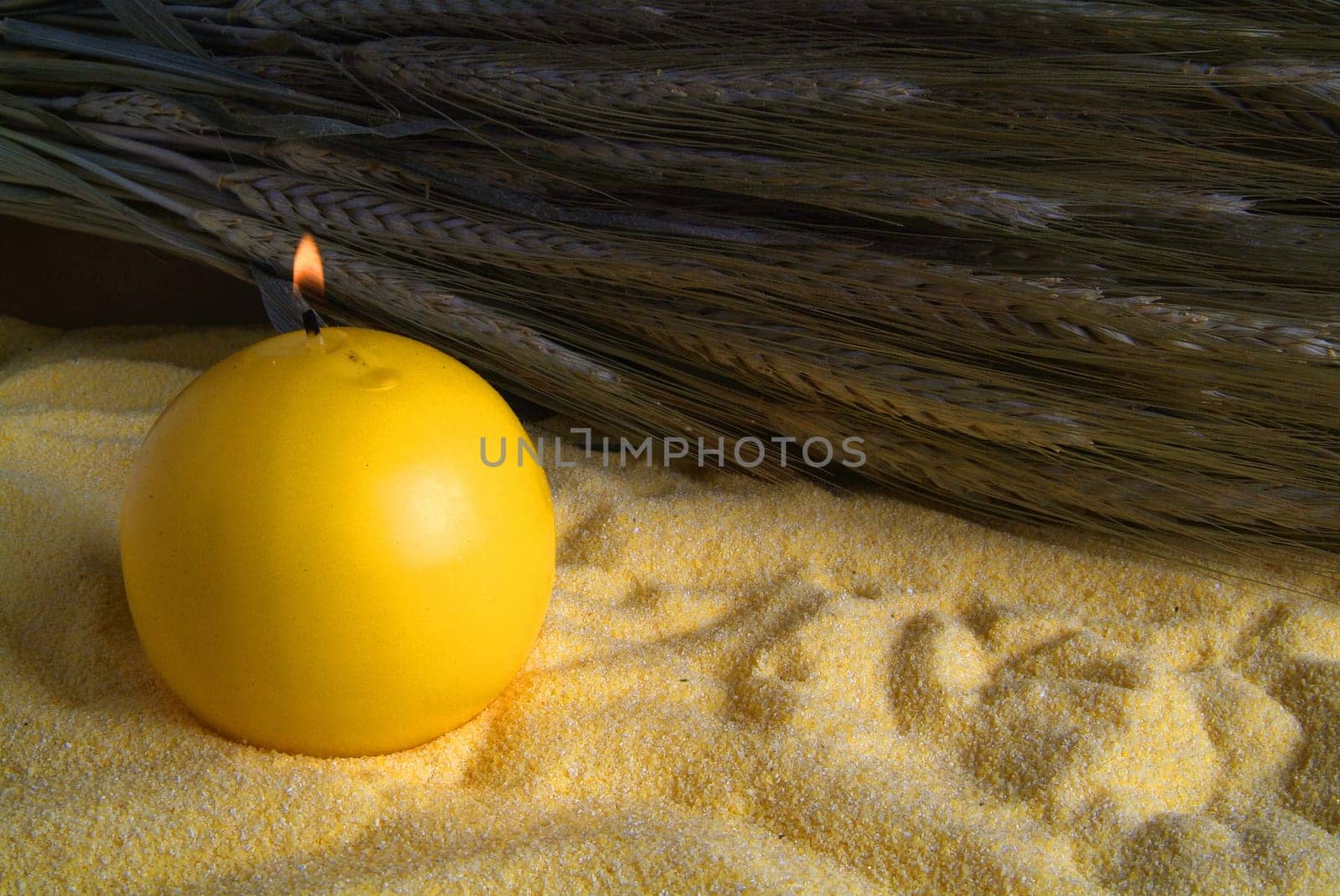 lighted candle and flour with bunch of oats