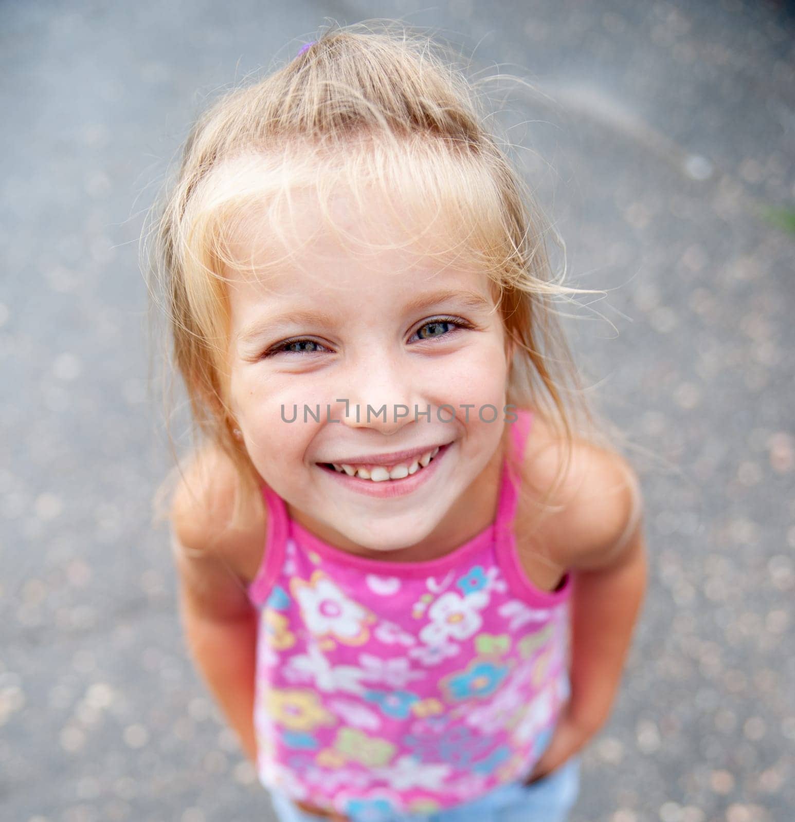 Girl Smiling In A Close-Up Portrait