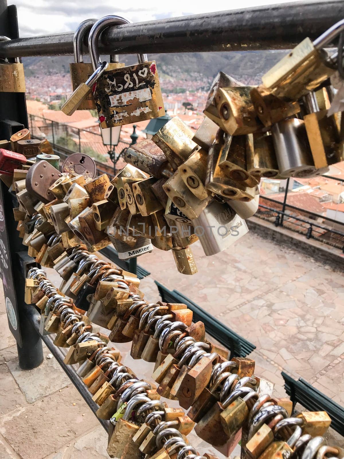 Padlocks attached to a railing in cusco, peru, represent enduring love and commitment