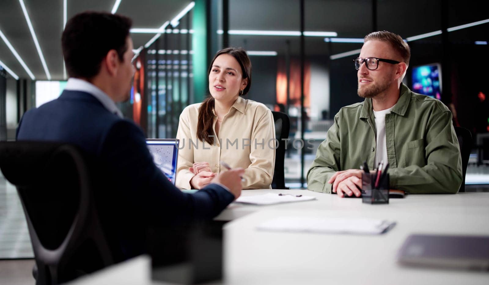 Young Couple Discussing Their Financial Future With A Hispanic Financial Planner