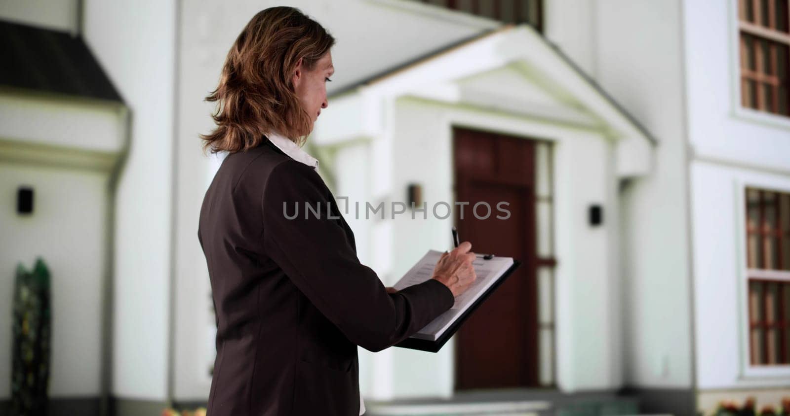 The Real Estate Agent Conducts A Property Appraisal By The Beach