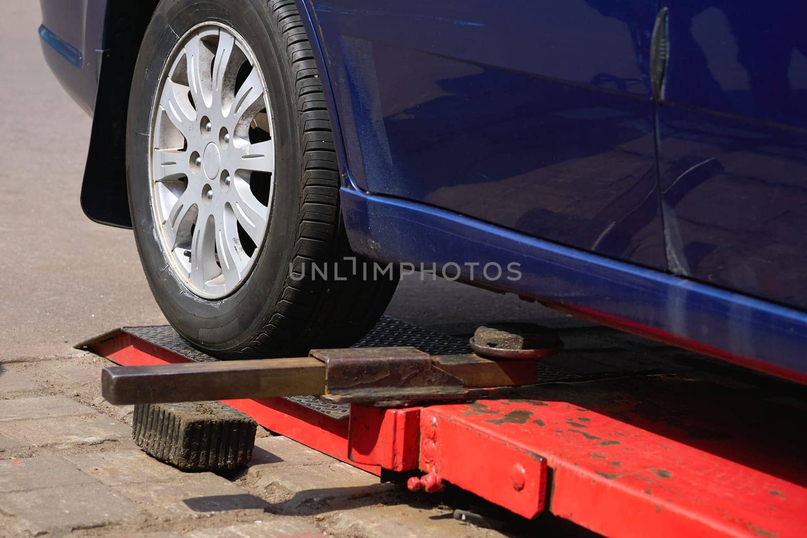 Replacing a car wheel at a tire station. a rubber covering, typically inflated or surrounding an inflated inner tube