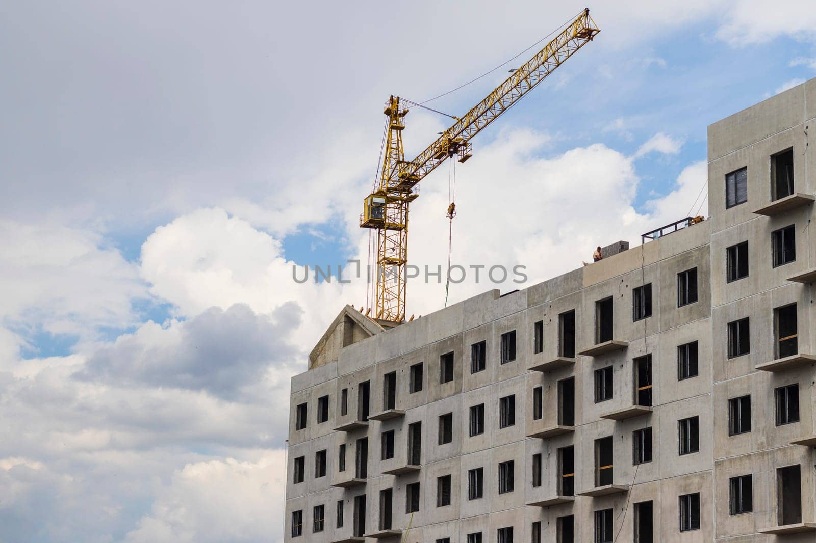 Industrial crane next to the building under construction