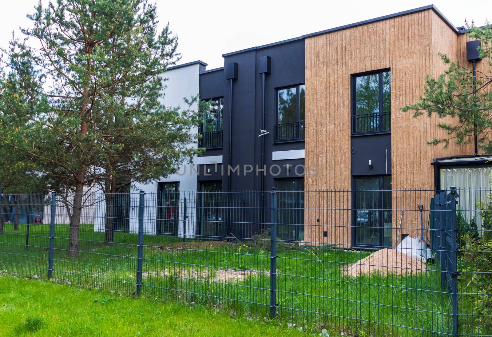 Facade of the stylish, urban, modern townhouses, ergonomically designed and made of ecological materials