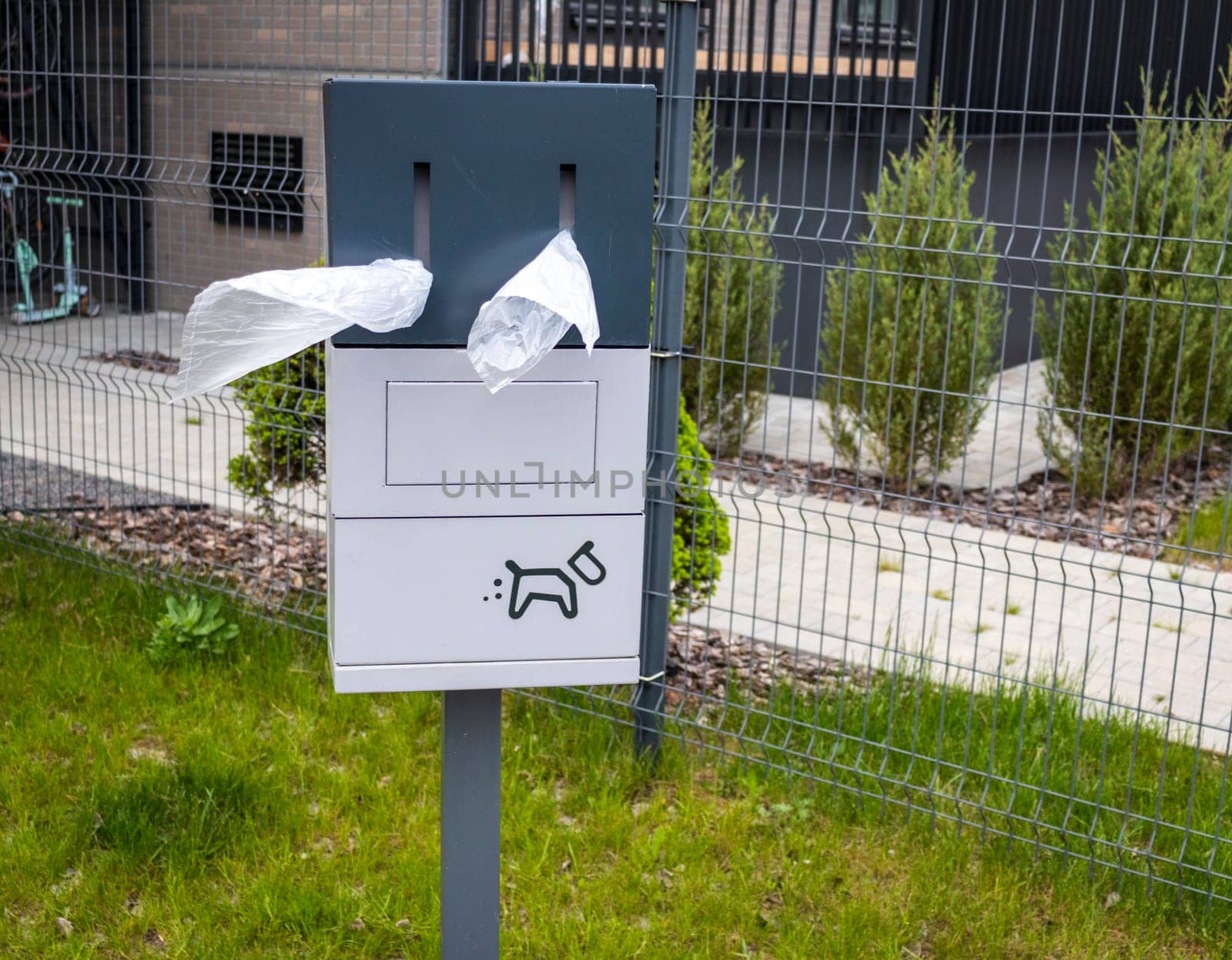 Close up shot of the box with single use plastic bags used for cleaning off pets excrement in the park