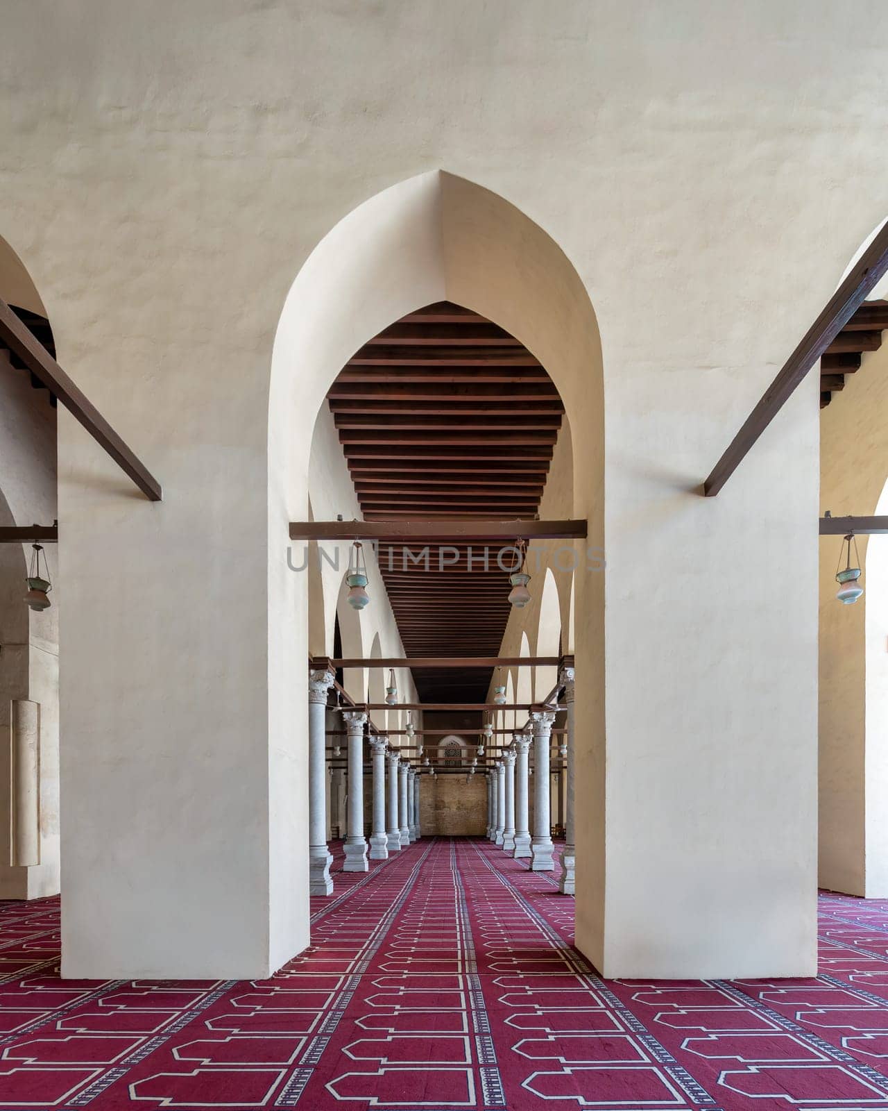 The Al-Zahir Baybars Mosque in Cairo is a testament to Egypt's profound Islamic heritage, characterized by its towering columns, arched passages, and intricately decorated prayer carpet
