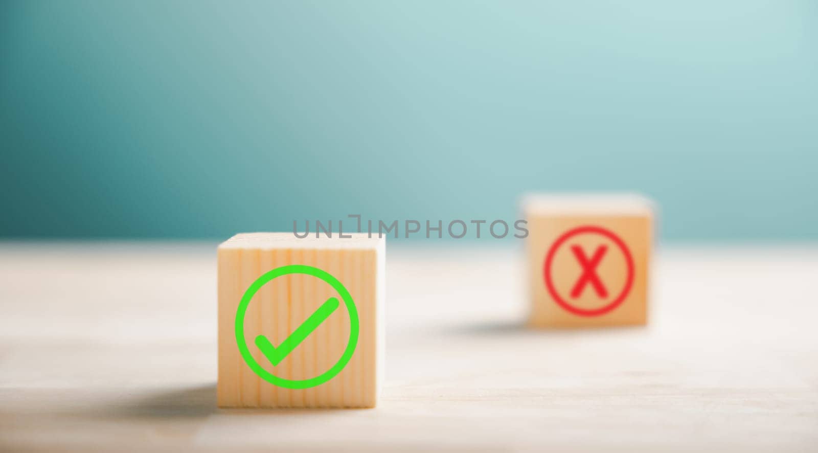 Wooden block featuring green check mark and red x. Conceptualizes choice and decision making. Think With Yes Or No Choice.