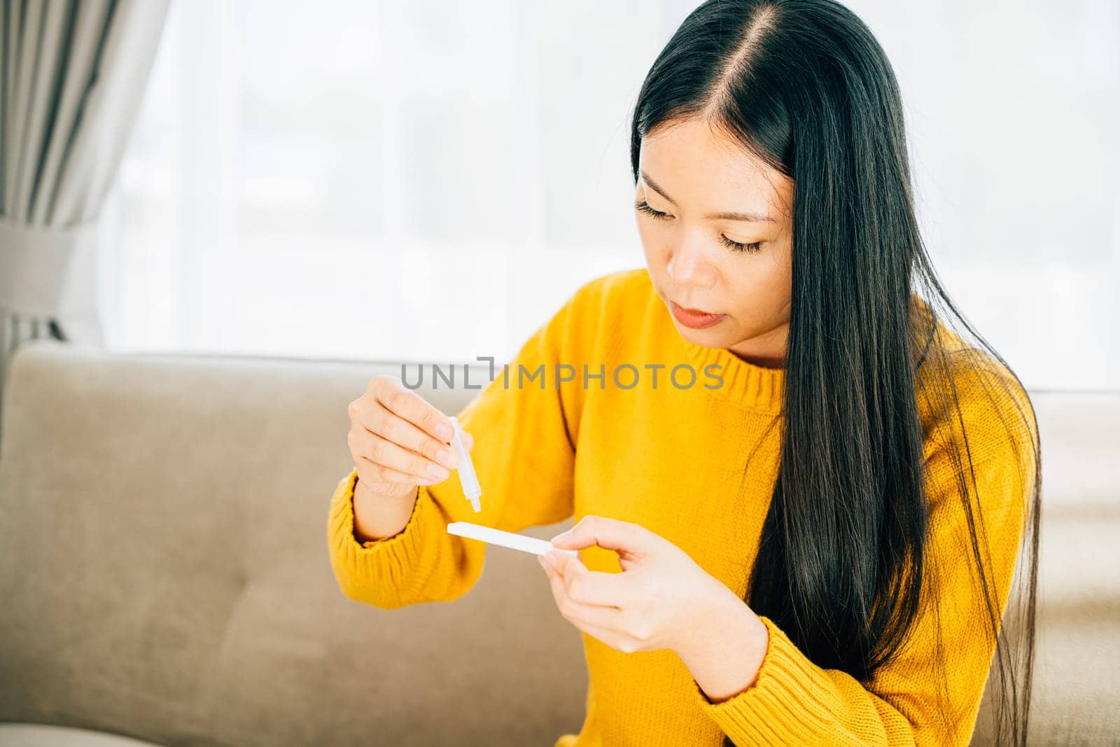 Illustrating COVID-19 self-test, Woman at home uses a rapid antigen test kit inserting a swab into her nose. Depicting virus prevention and pandemic protection measures.