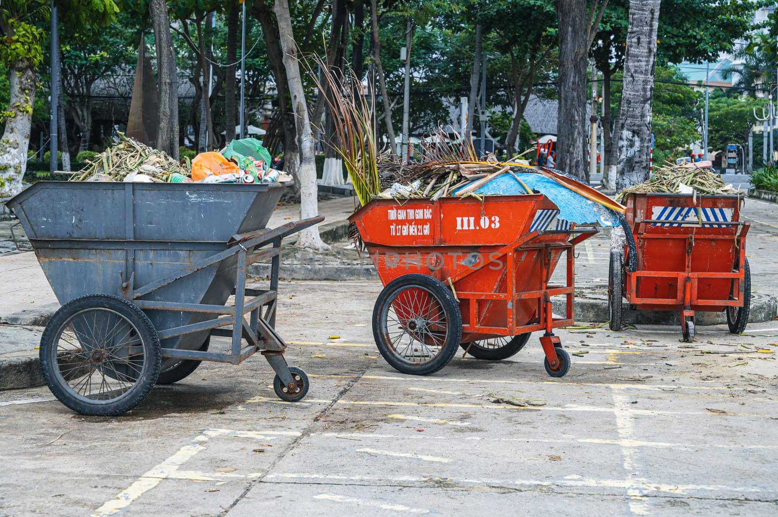 Metal containers full of garbage are standing on a beach in Asia. Nha Trang, Vietnam - December 14, 2024.
