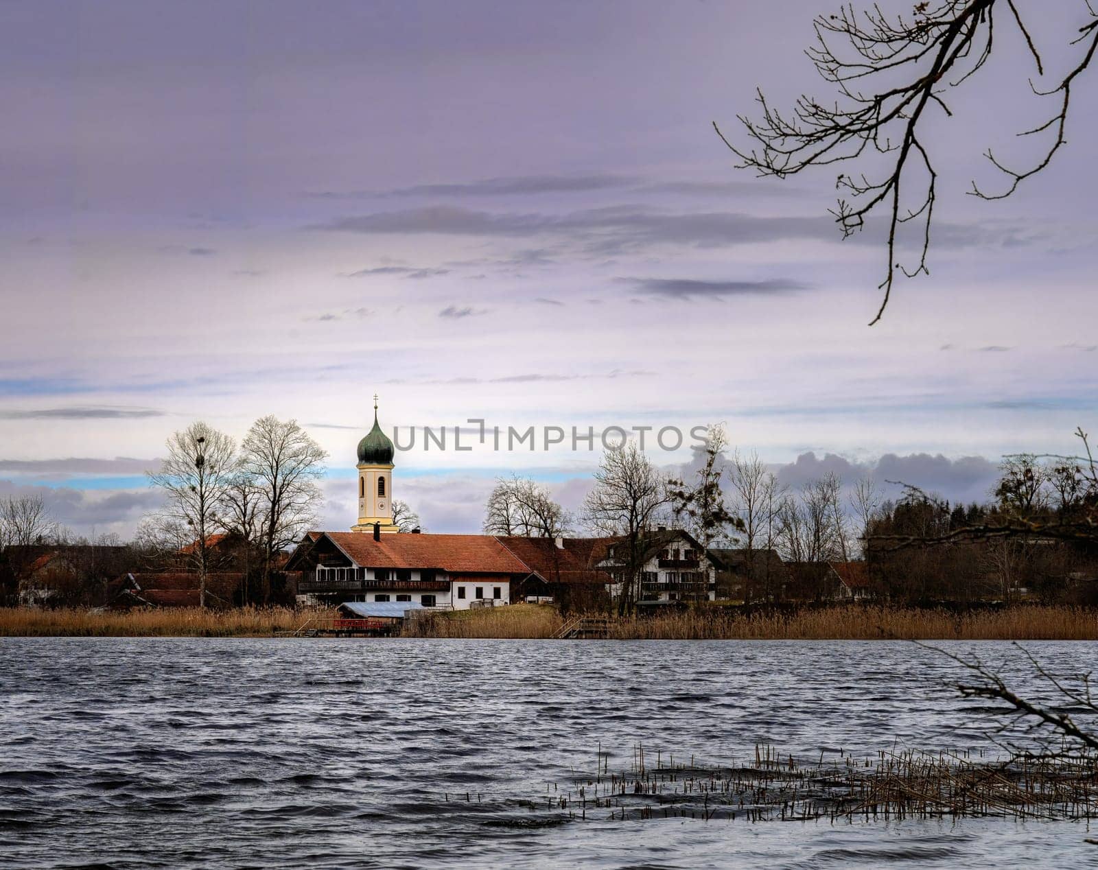 Church at a lake in Bavaria called Froschhauser See on a windy day