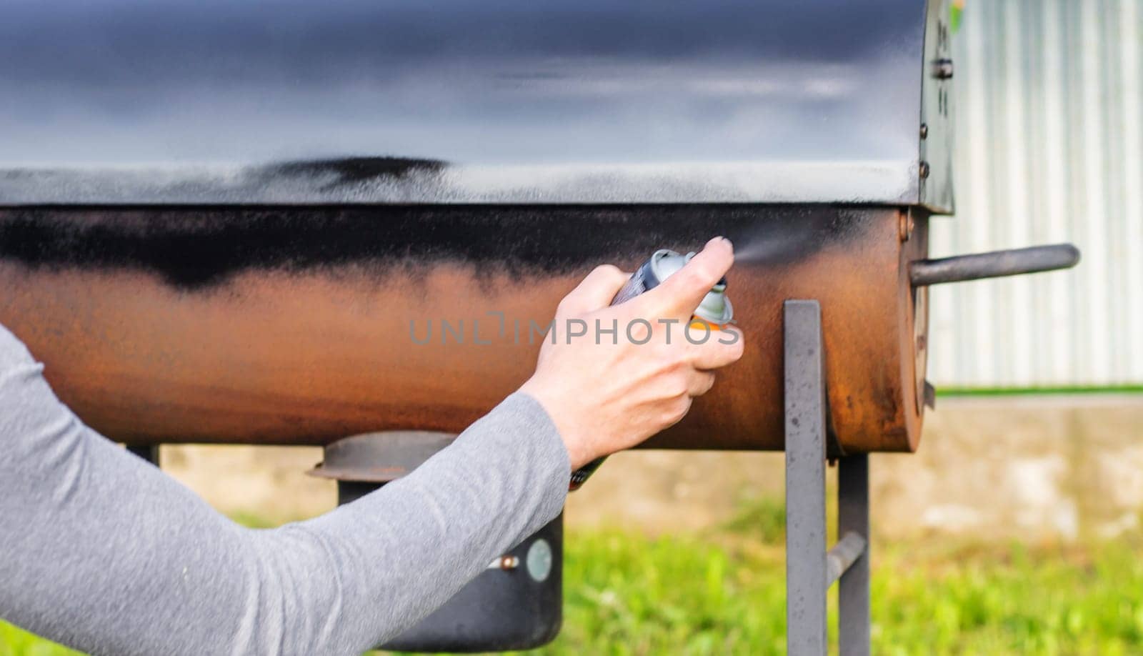 Man painting with spray paint. Selective focus. people.