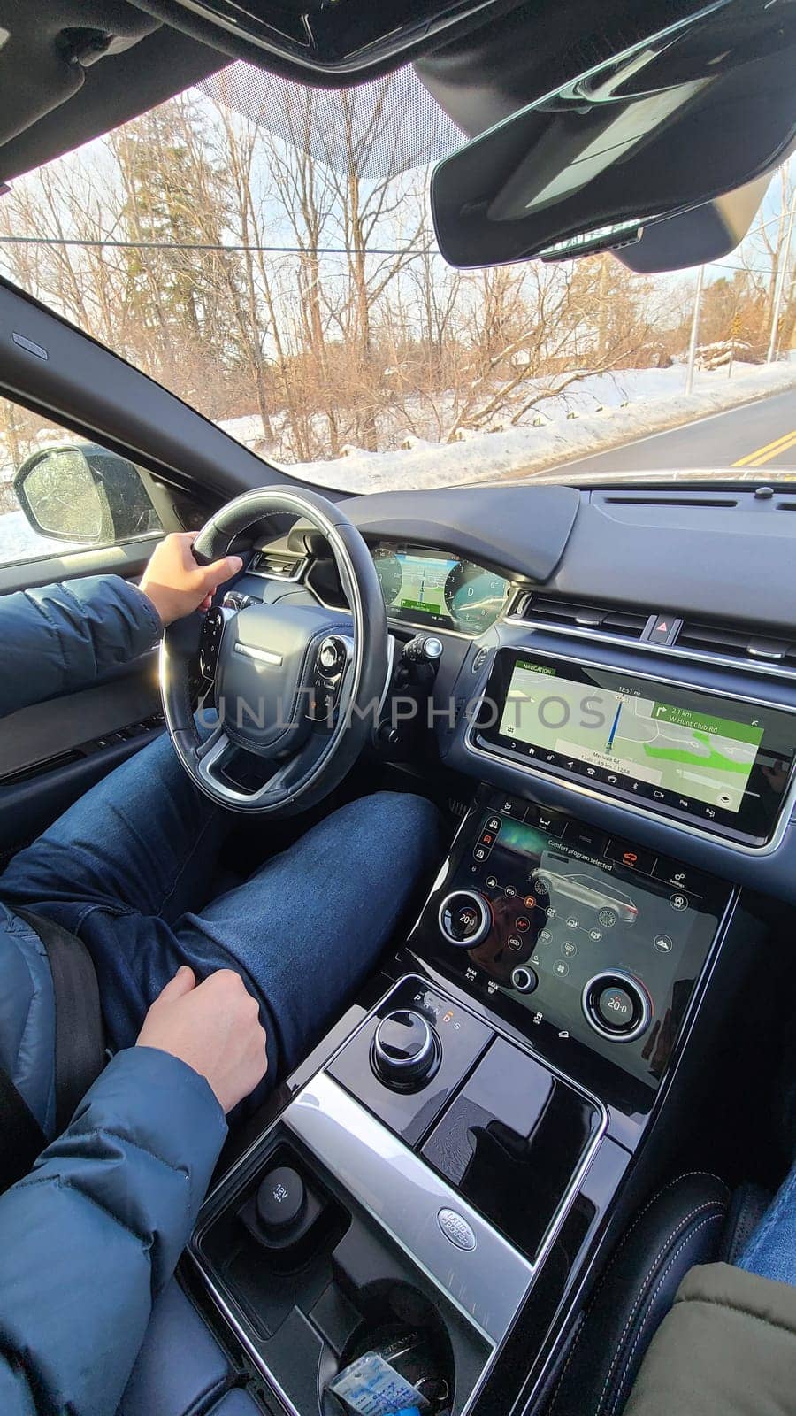 Ottawa, ON Canada - 12.29.2024: Driving Through Winter Landscape Person Behind the Wheel Navigating Snowy Roads, Vehicle Interior.