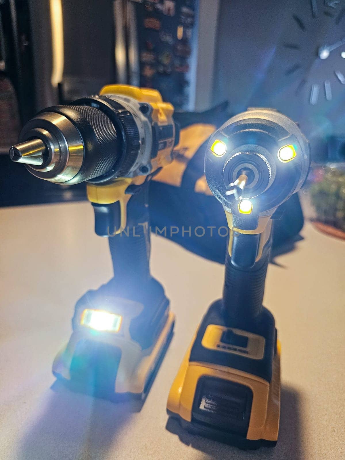 Ottawa, ON Canada - 04.23.2024: Two Cordless Power Yellow DeWalt Tools Side by Side on a Workbench Surface with Lights On, Ready for Work.