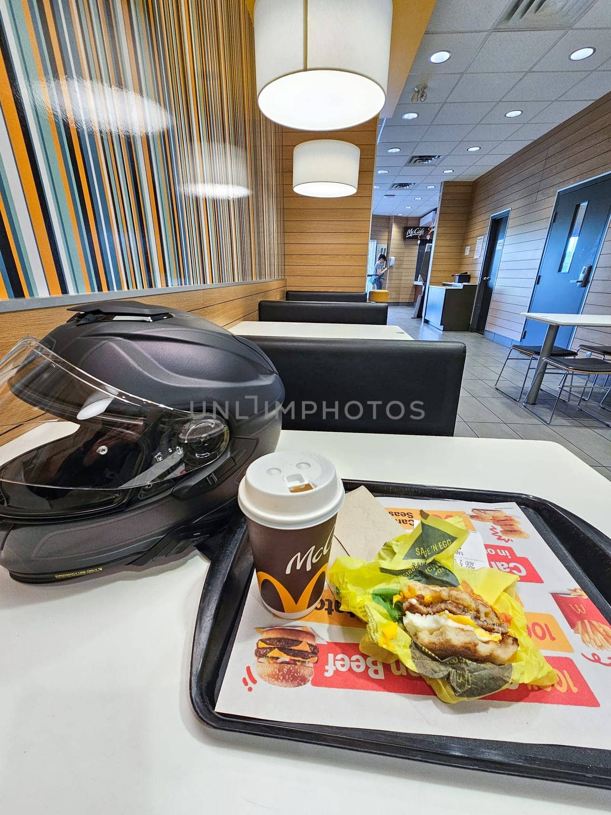 Sargent s Purchase, NH USA - 08.22.2024: Motorcycle Rider s Meal Stop Helmet, Coffee, and a Quick Bite at a Diner, Perfect Break.