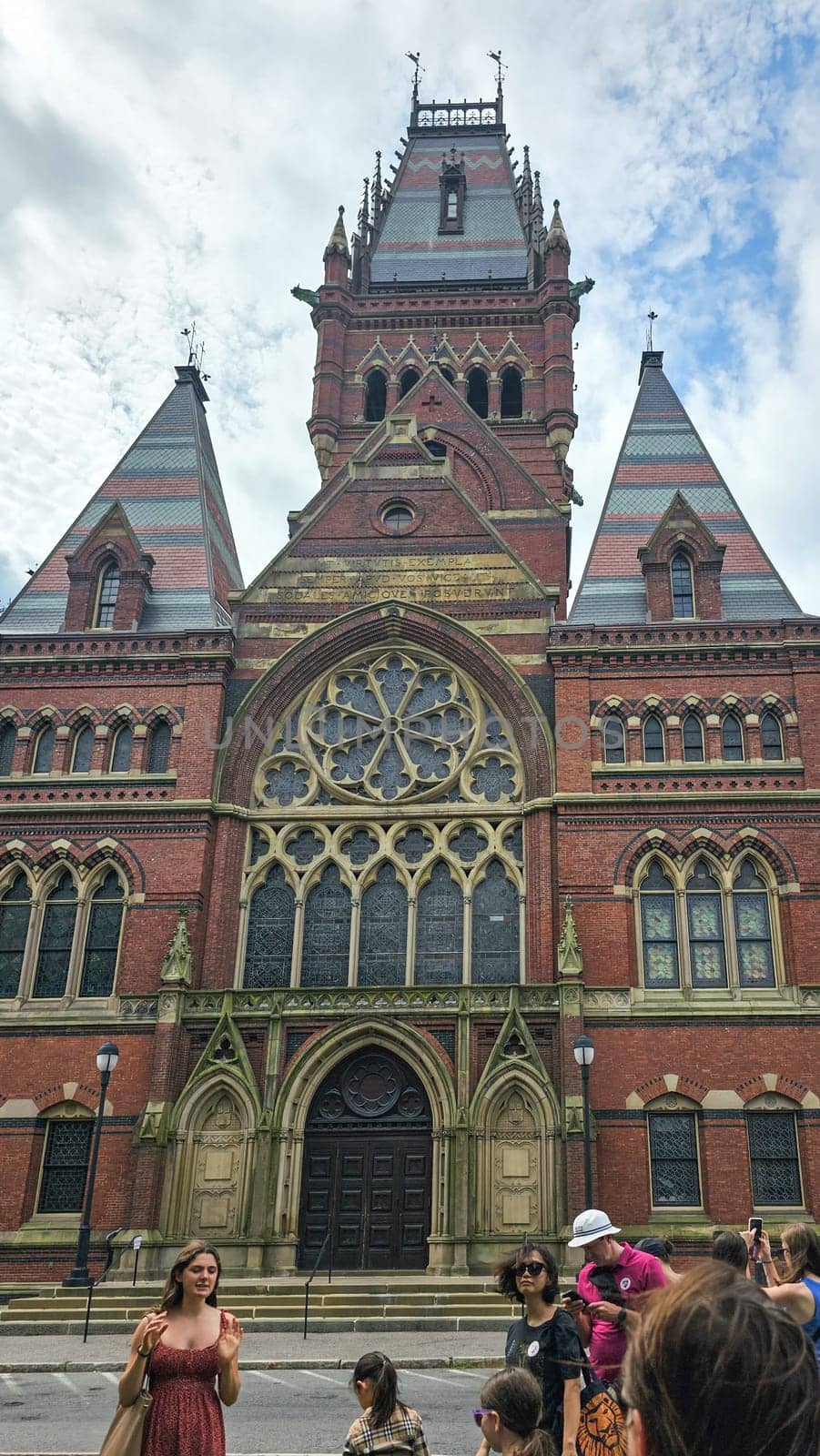 Boston, MA USA - 08.04.2024: Historic Harvard University Building Facade with Ornate Architectural Detail and Tourists below.