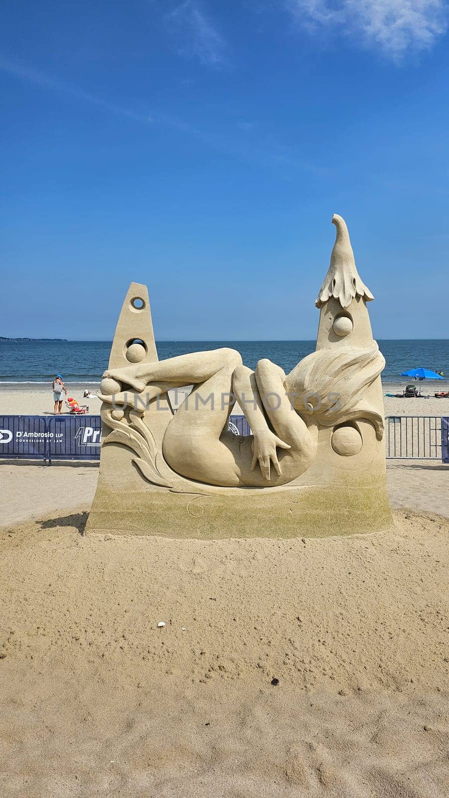 Boston, MA USA - 08.05.2024: Impressive Sand Sculpture of a Reclining Woman on a Sunny Beach, Summer Vacation.