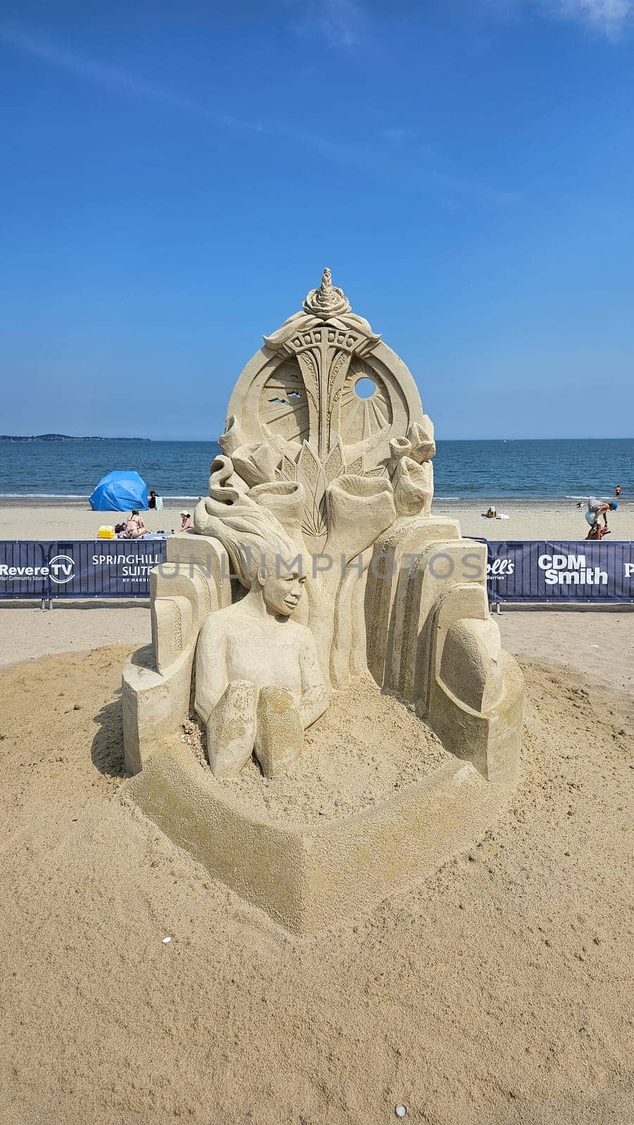 Boston, MA USA - 08.05.2024: Impressive Sand Sculpture Artistry on Beach Display, Crafted Seated Figure and Ornamental Design