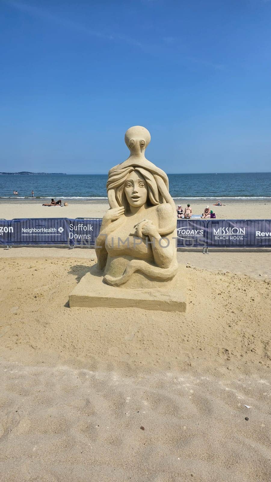 Boston, MA USA - 08.05.2024: Intriguing Sand Sculpture of Woman and Octopus on Beach, Coastal Art and Marine Theme