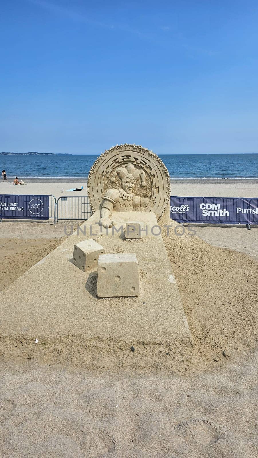 Boston, MA USA - 08.05.2024: Jester Sand Sculpture with Dice on Beach, Creative Art Display, Summer Fun.
