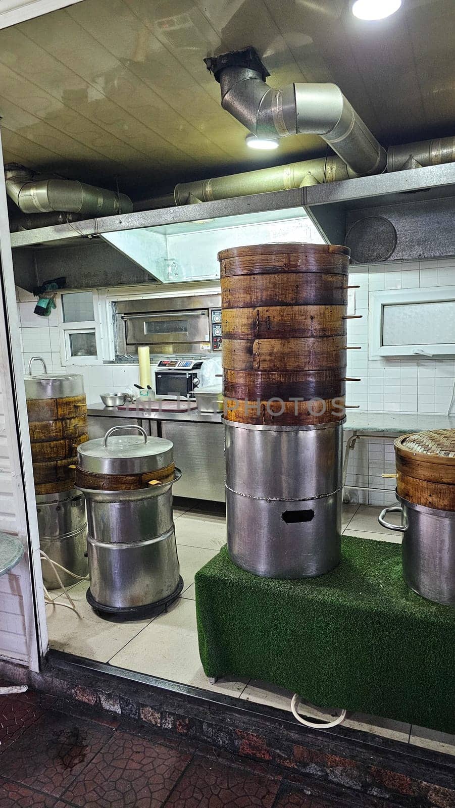 Bishkek, Kyrgyzstan - 10.05.2024: Traditional Bamboo Steamer Stacks in Asian Restaurant Kitchen, Culinary Preparation Area.