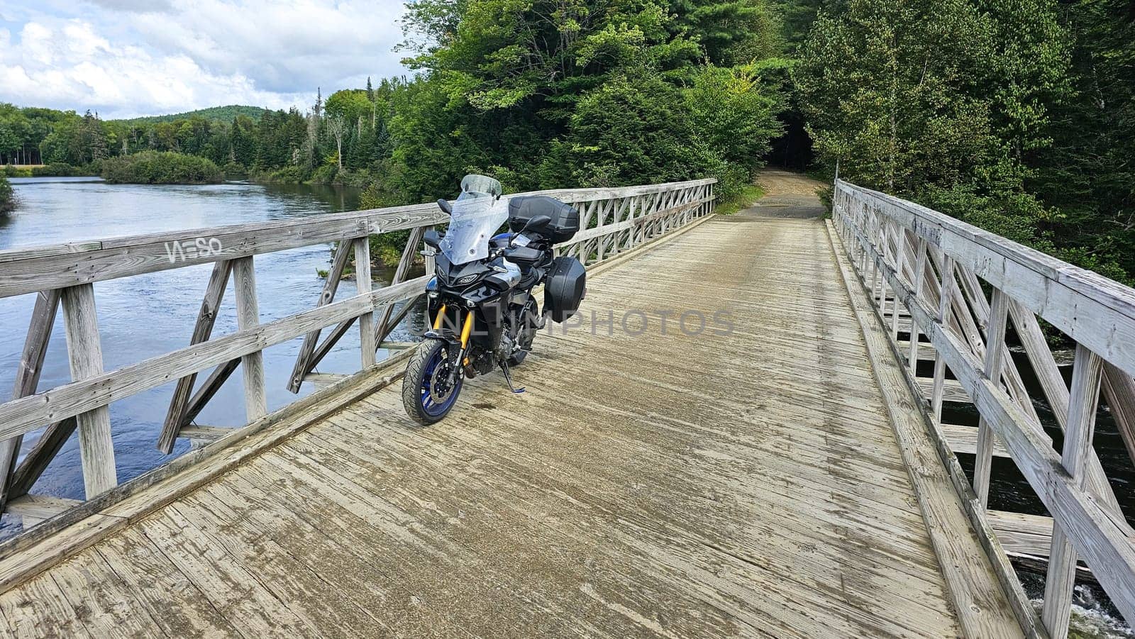 Sargent s Purchase, NH USA - 08.22.2024: Motorcycle Adventure on Wooden Bridge Exploring Scenic Landscapes and Nature Views.