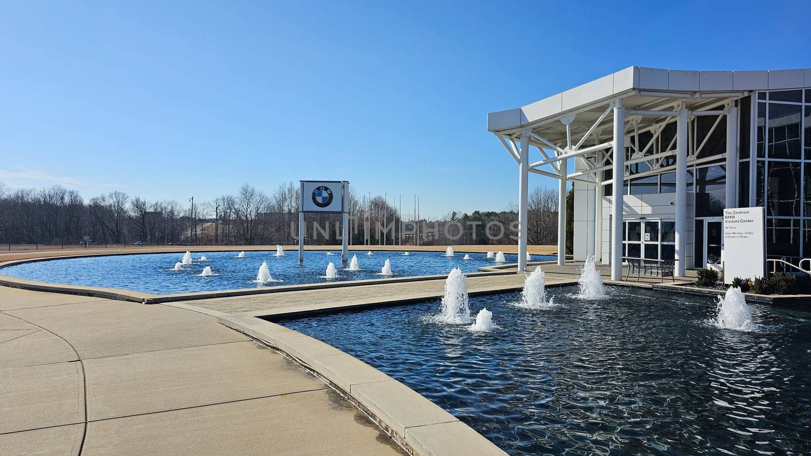 Greer, SC USA - 12.25.2024: Reflective Fountain and Modern Architecture on a Sunny Day, Outdoor Space.
