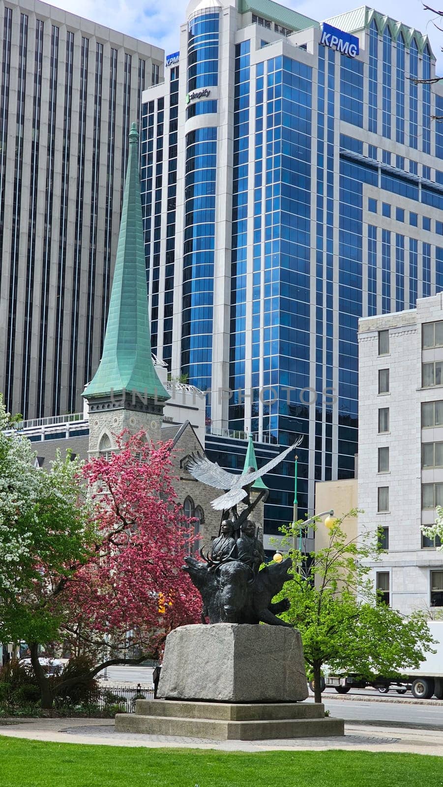 Ottawa, ON Canada - 05.14.2025: Ottawa Skyline Historic Church Spire, Modern Buildings, and a Majestic Sculpture in Canada.
