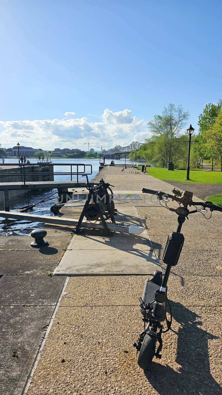 Ottawa, ON Canada - 05.14.2025: Exploring Scenic Ottawa Locks with an Electric Scooter on a Sunny Day, Canada.