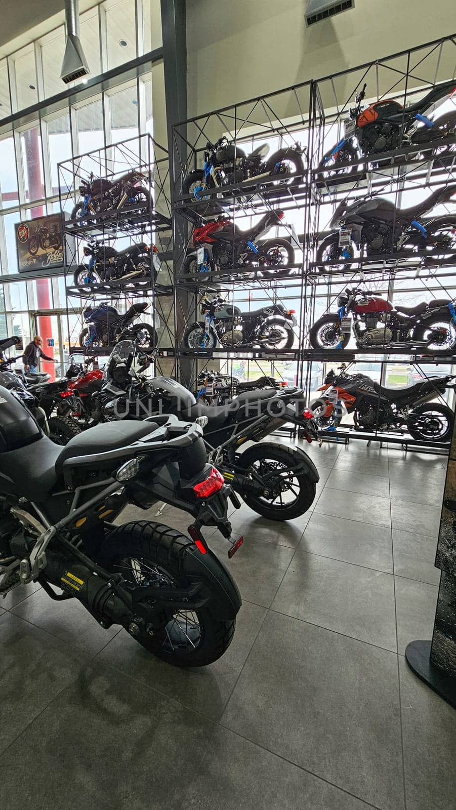 Ottawa, ON Canada - 05.10.2025: Motorcycle Showroom Display Rows of Bikes on Shelves for Sale and Viewing, Interior Shot.
