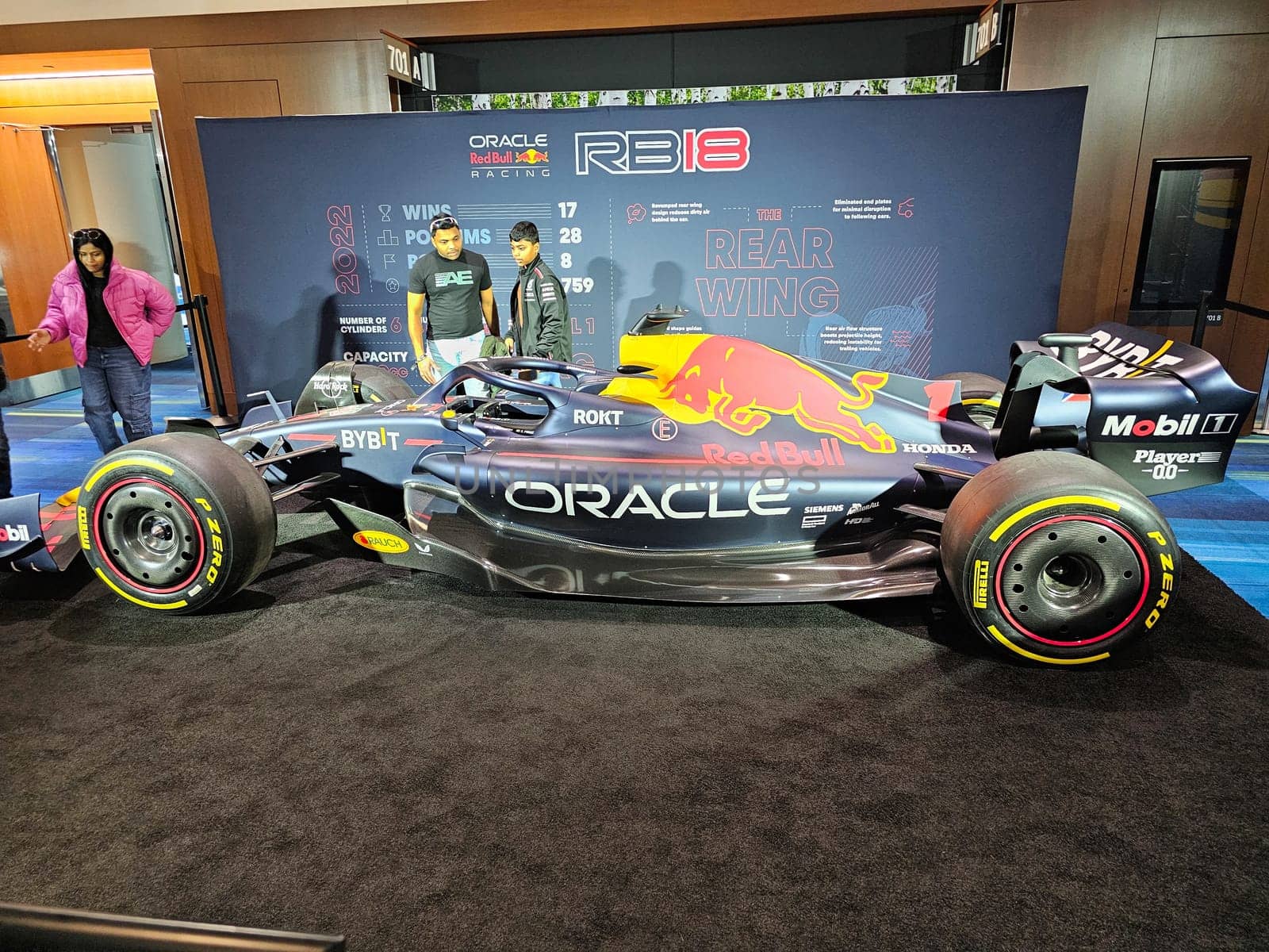 Toronto, ON Canada - 02.23.2024: Sleek Open Wheel Racing Car Displayed at Event with Spectators and Team Members.