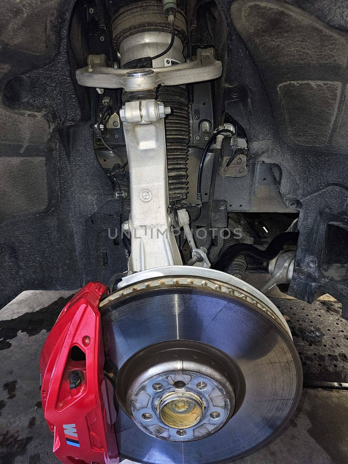 Ottawa, ON Canada - 03.02.2024: Car Suspension System Detailing a Brake Rotor, Caliper, and Strut Assembly on Display.