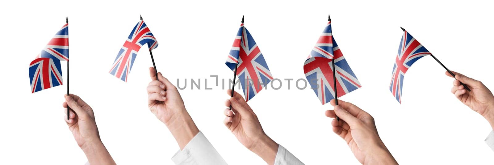 The United Kingdom flag in hand in different angles on a white background.