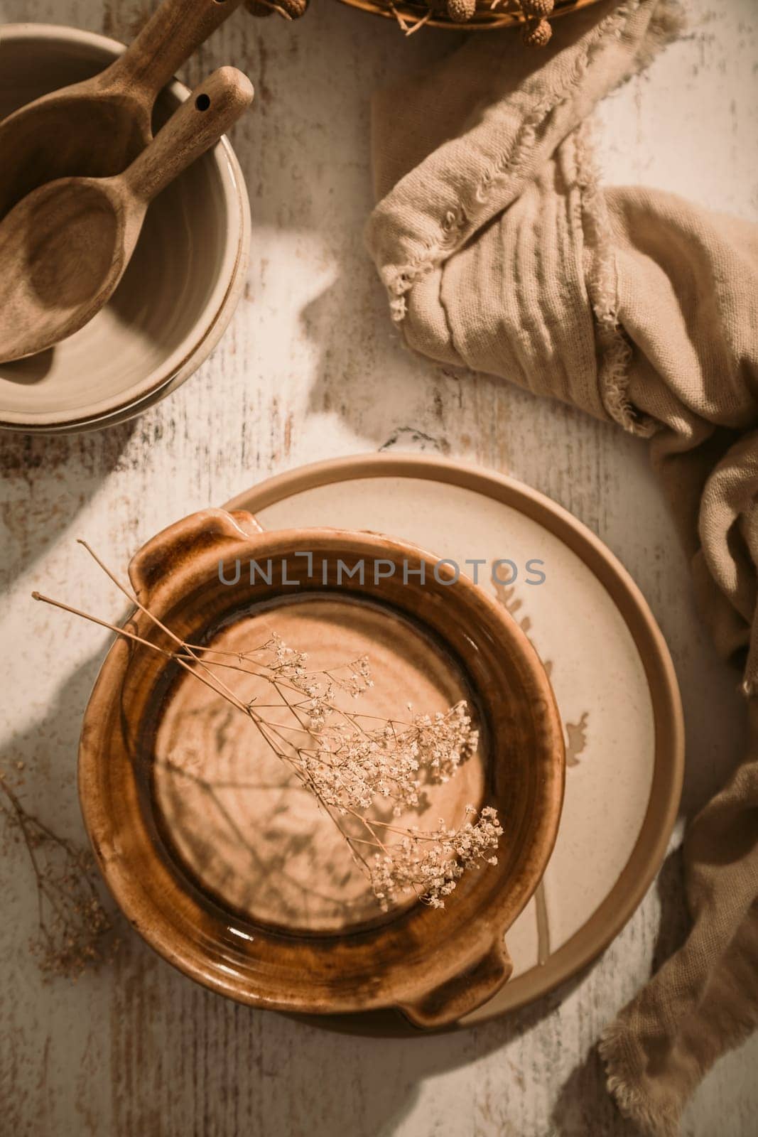 Set of ceramic tableware. Empty craft ceramic plates, bowls and cups kitchen table