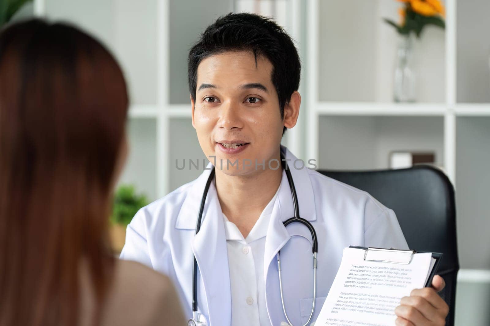 A doctor attentively explaining a treatment plan to a patient, fostering understanding and transparency in a supportive healthcare environment.