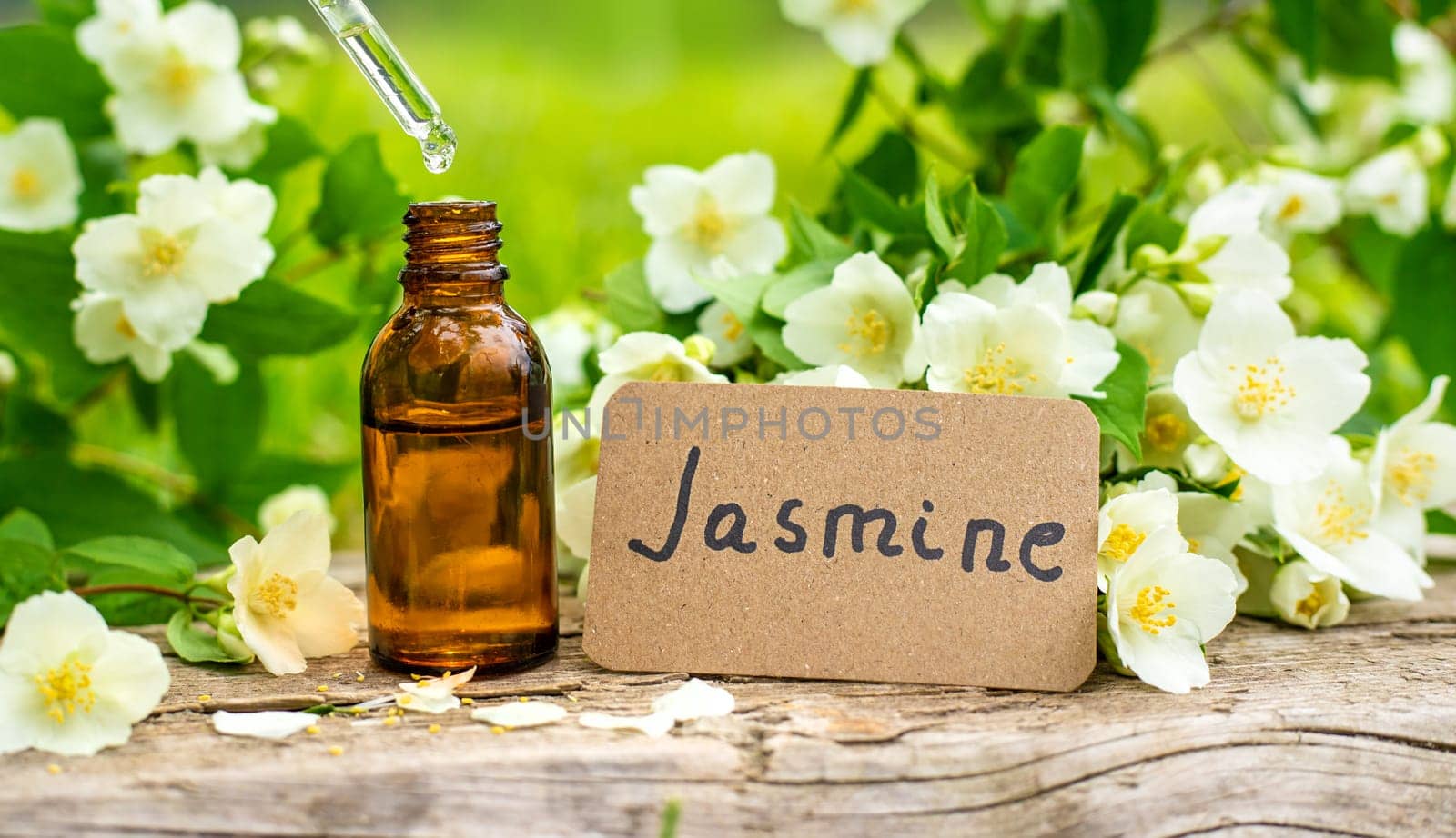 Jasmine essential oil and flowers. Selective focus. nature.