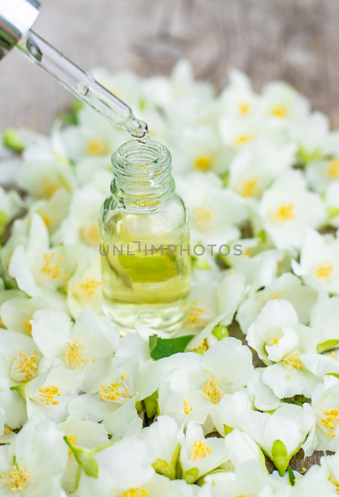 Jasmine essential oil and flowers. Selective focus. nature.