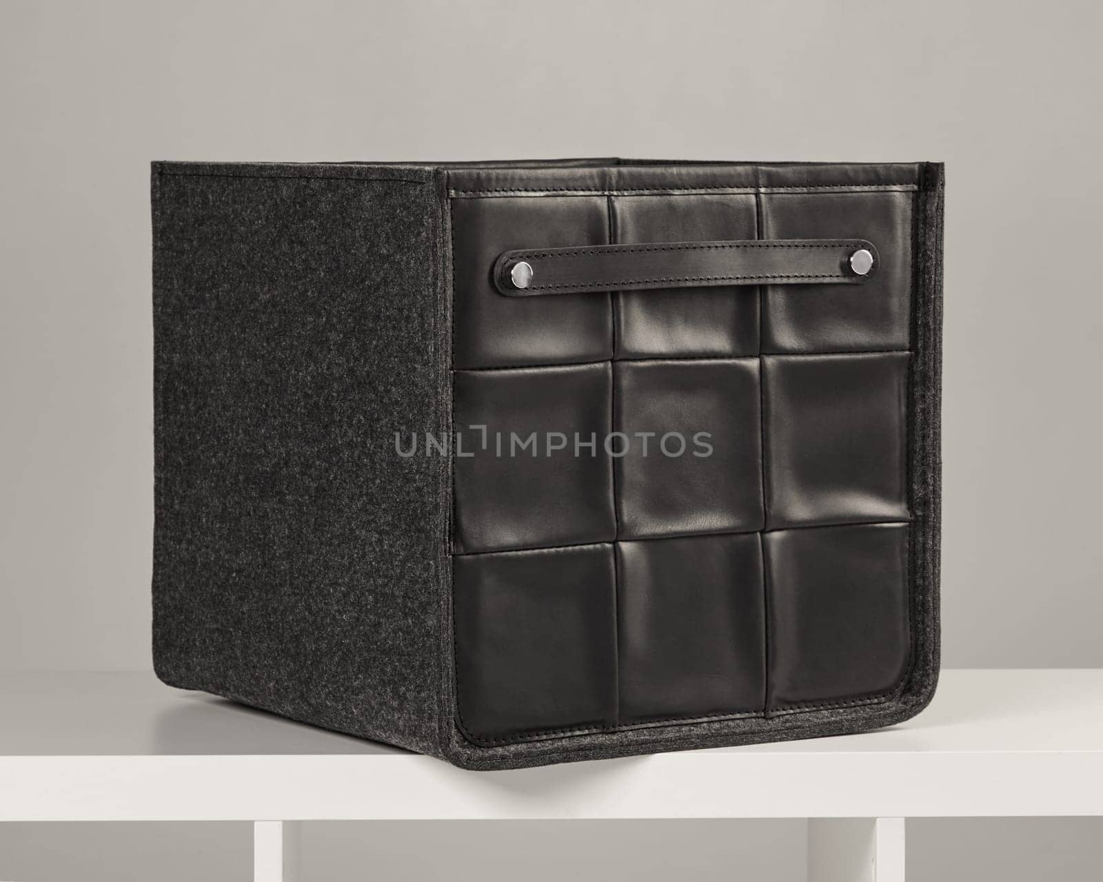 Stylish storage box combining black leather and gray felt, ideal for organizing belongings