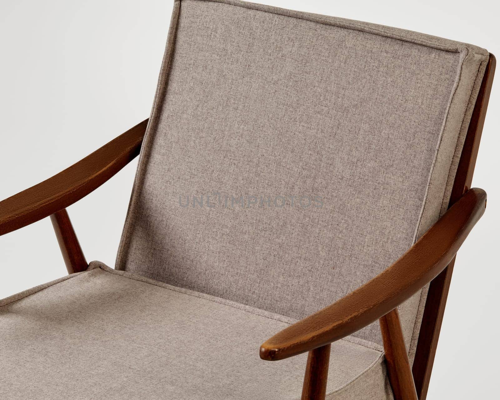 Comfortable modern armchair with wooden frame and soft beige upholstery offers a stylish seating solution