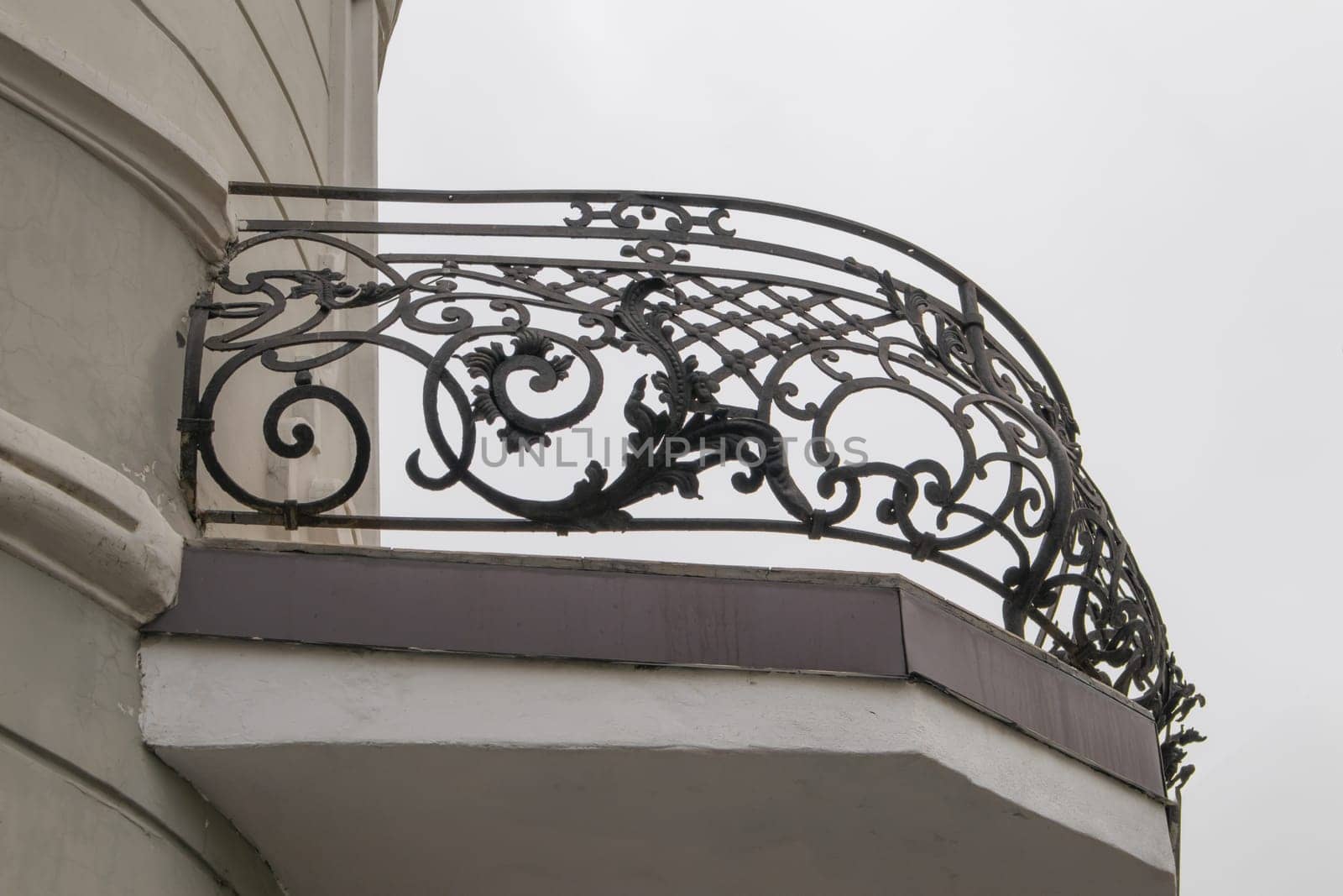 Forged semicircular balcony lattice fence with monograms, closeup.
