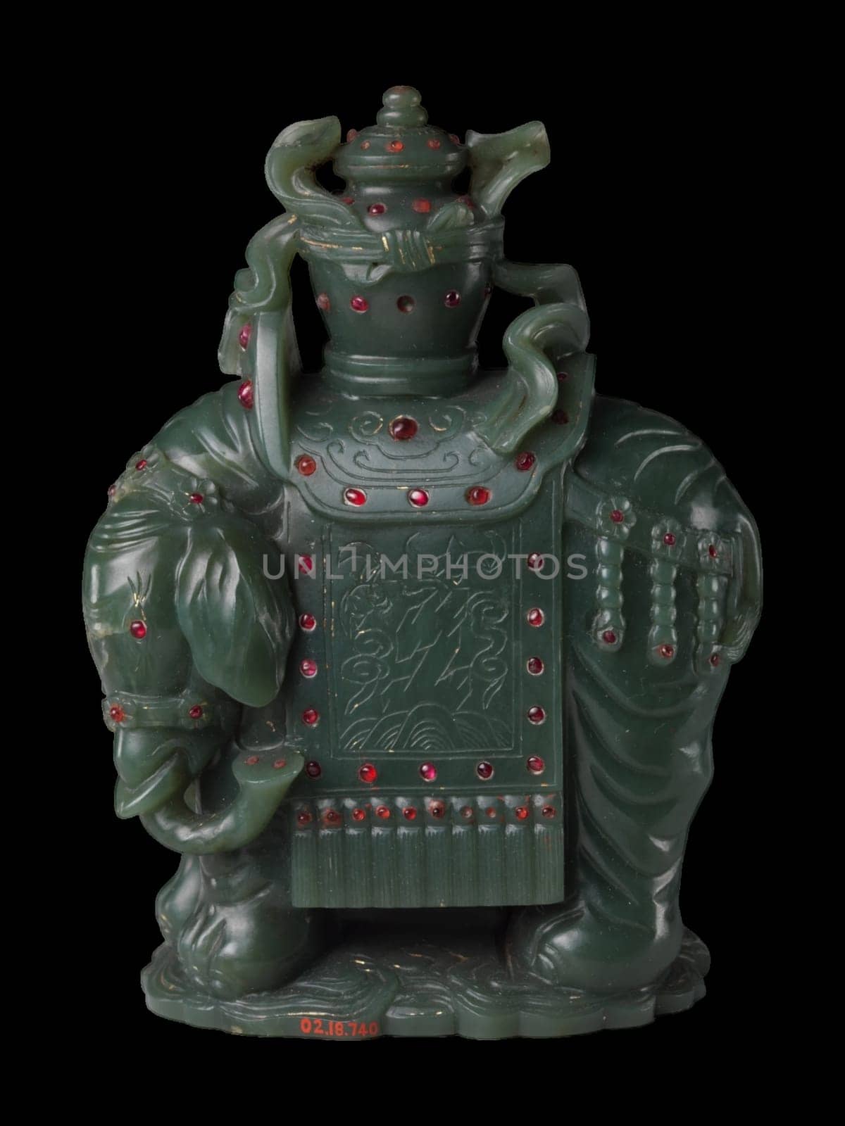 Intricate 18th-19th century Chinese carving of a dark green jade elephant carrying a vase, adorned with red accents. Symbol of strength and peace.