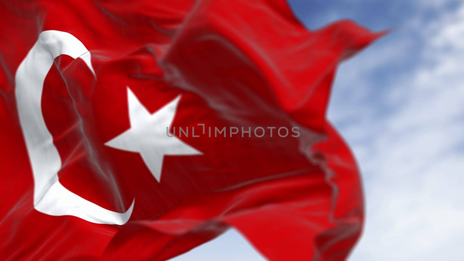 Close-up of Turkish national flag waving in the wind on a clear day. Red flag with white crescent and a star. 3D illustration render. Fluttering fabric. Selective focus