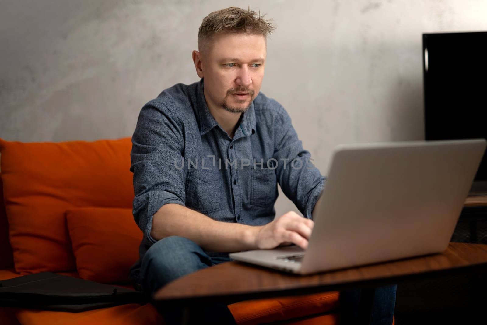 Man Working Remotely On Laptop At Home