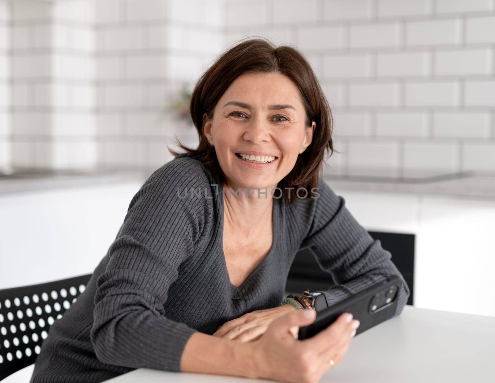 Young Woman Smiles At Home In Bright Room