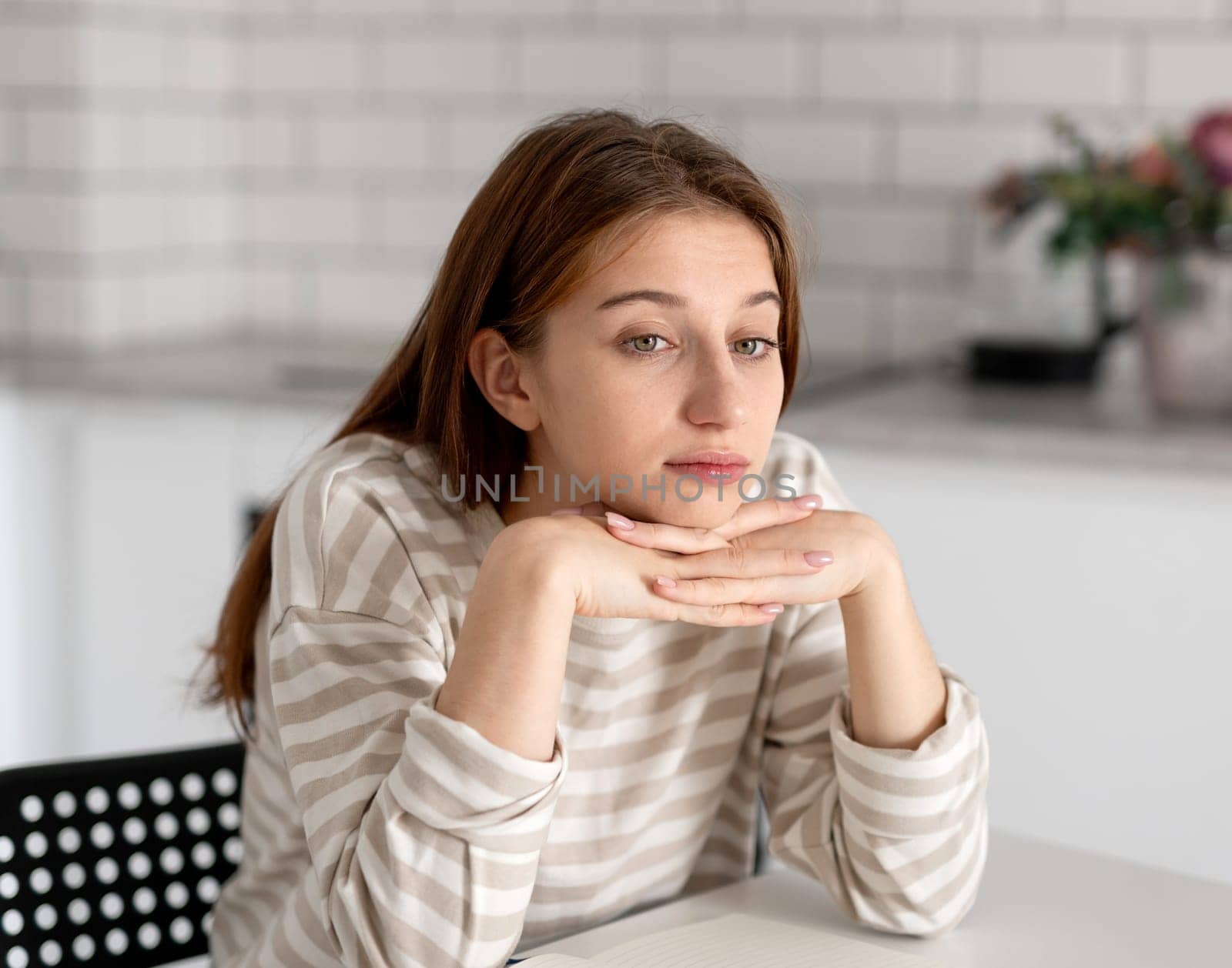 Thoughtful Teen Girl Dreaming At Home While Sitting At The Table