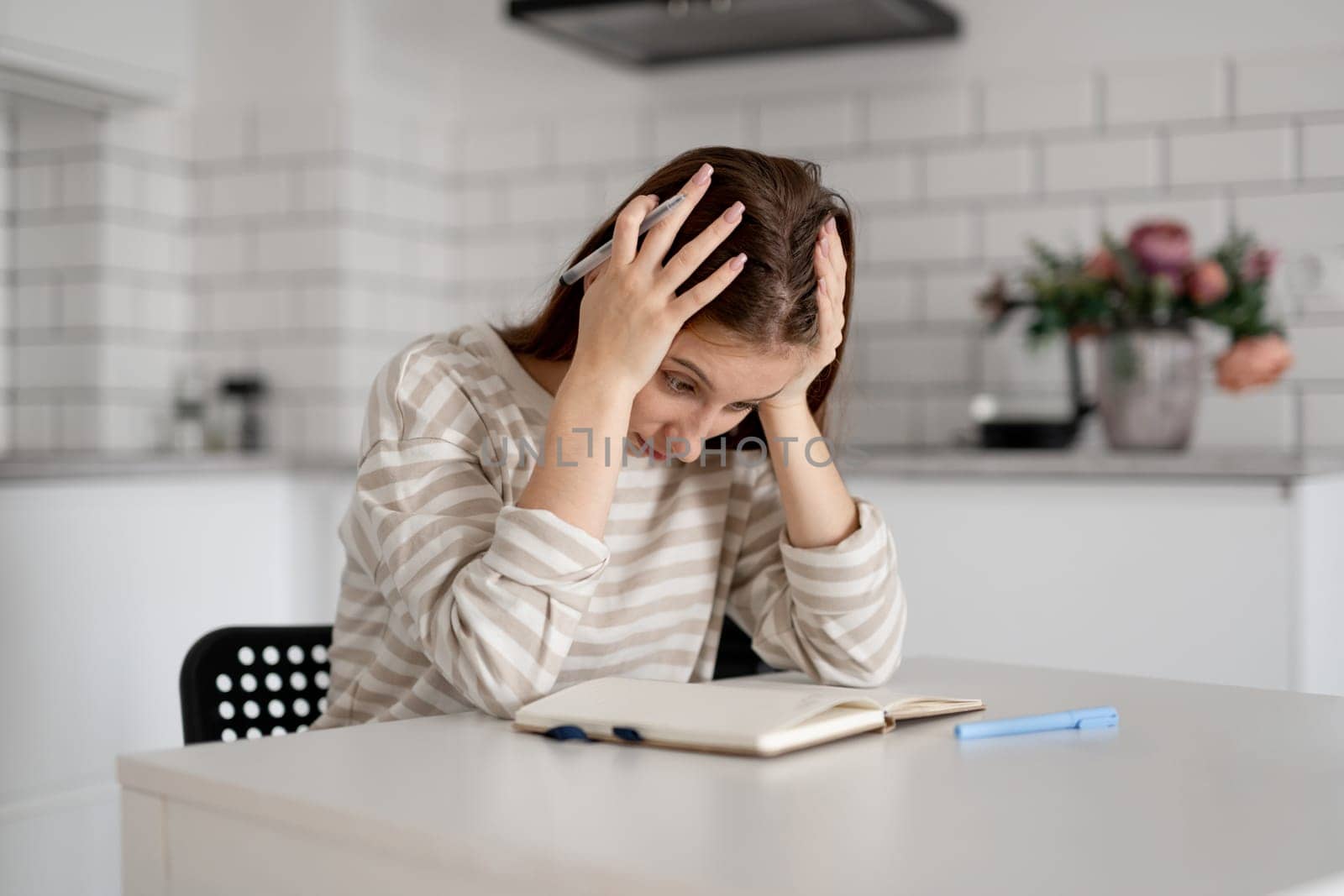 Girl Holding Head Over Difficult Homework Notes