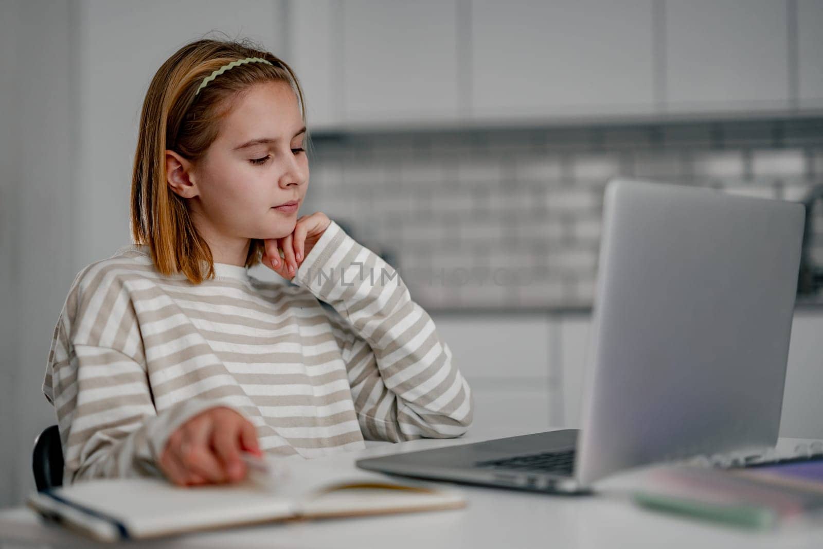Cute Little Girl Using A Laptop At Home Doing Homework And Learning With The Computer