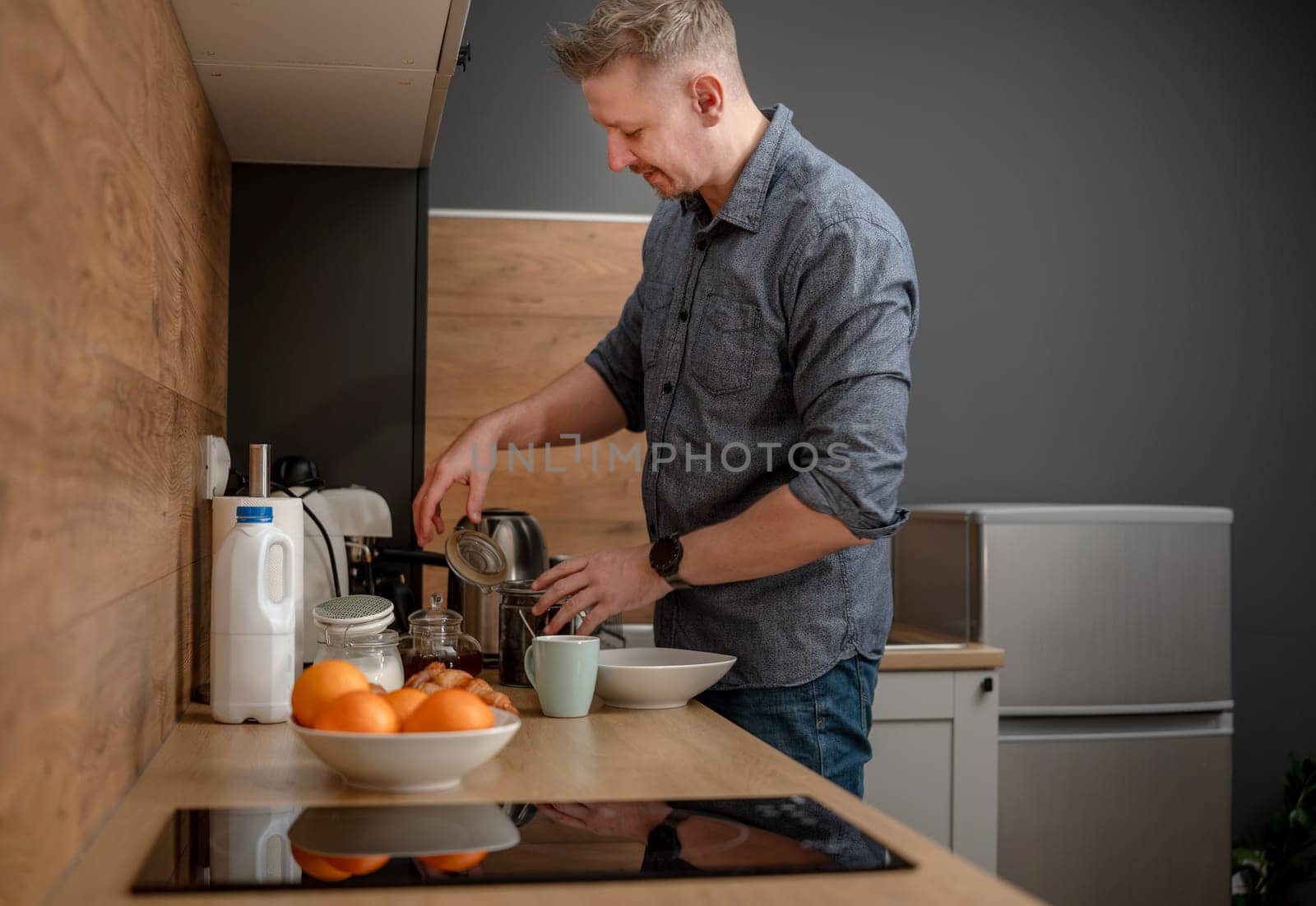 Man Making Coffee For Himself In The Kitchen In The Morning