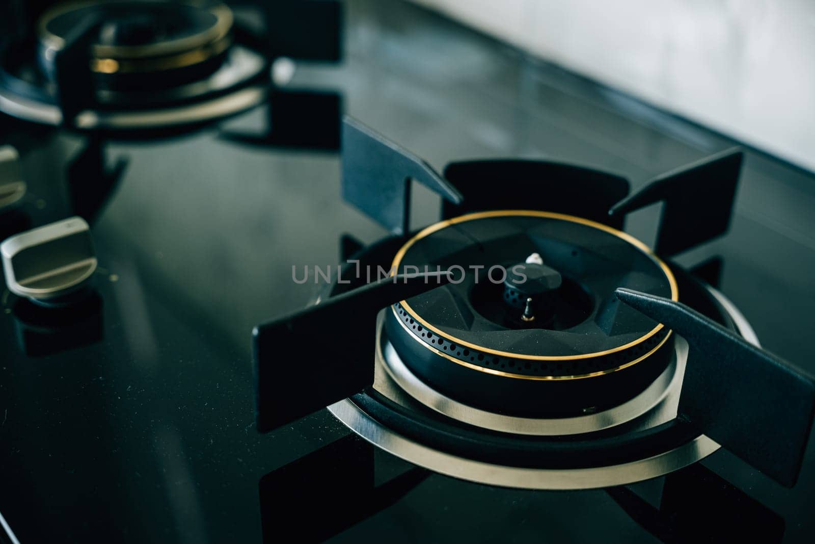 Luxurious black and gold stove top an opulent choice for high-end kitchens. Modern design clean appliance lavish addition to upscale house interiors give me.