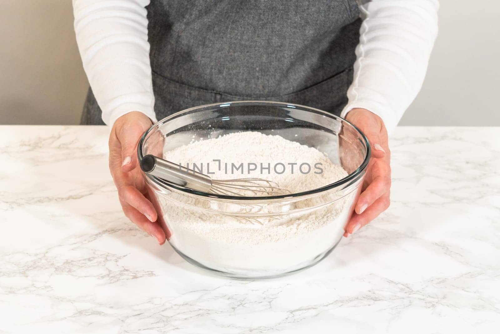A glass mixing bowl with dry ingredients including flour and warm spices, prepped for the Classic Red Gingerbread Dough. This blend will add depth and warmth to the final dough.